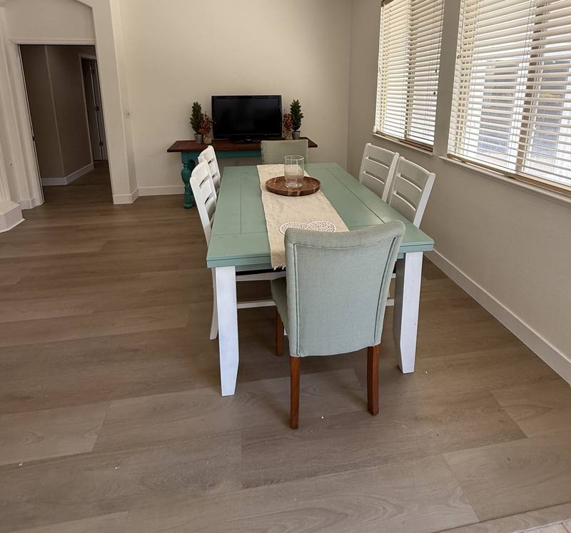 Dining room with a teal farmhouse table