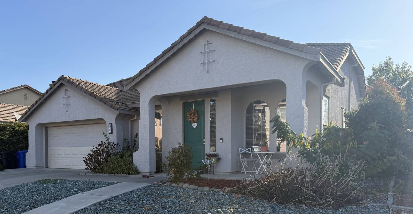 Front of the home with a covered porch and green front door