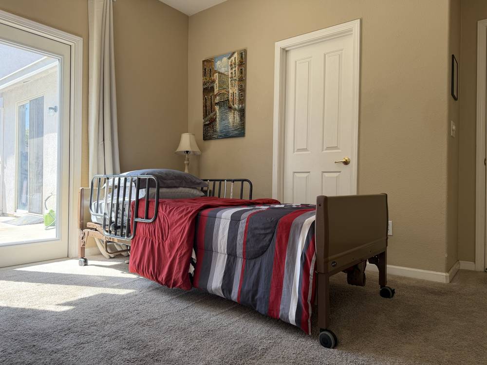 Sunny shared room with an adjustable bed and French doors to the patio
